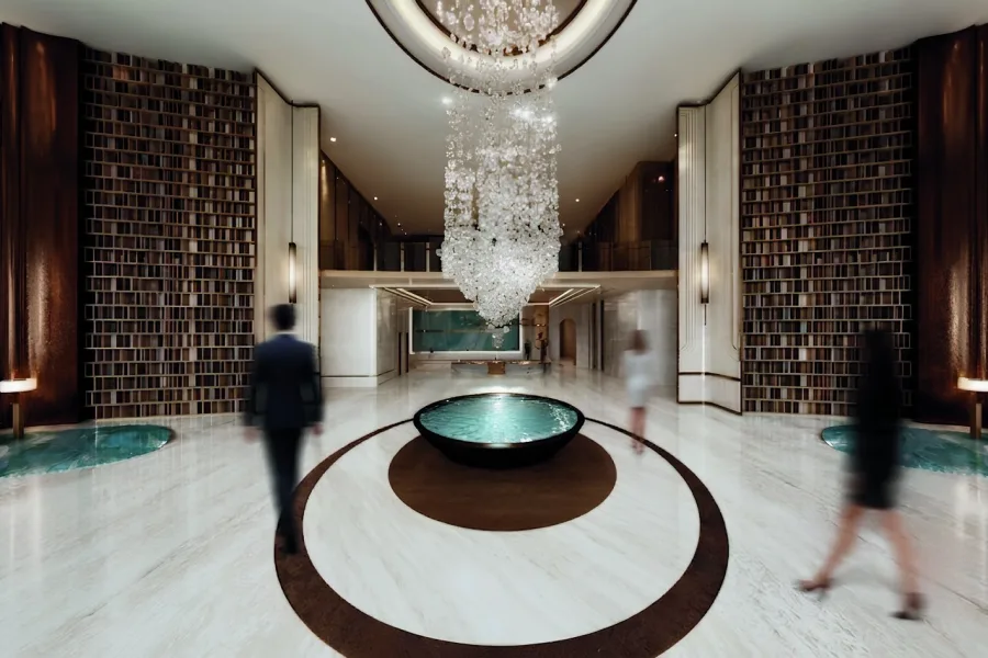 Architectural render: the hotel lobby and its water feature