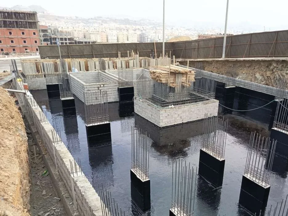 Foundations and basement walls coated with bituminous waterproofing